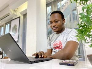 Man sat at a laptop, possibly conducting a remote interview